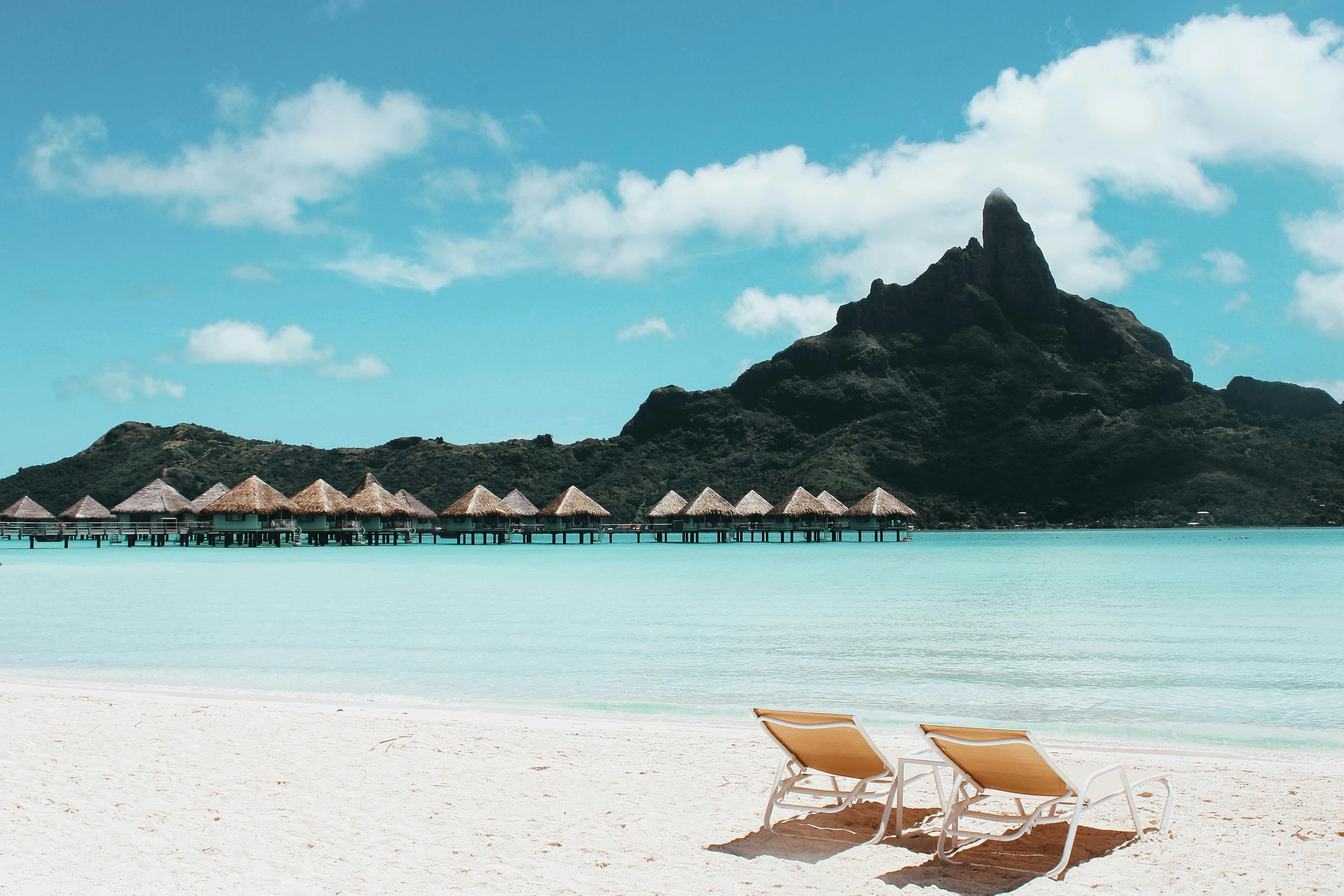 Overwater bungalows in Bora Bora with turquoise lagoon and iconic mountain peak